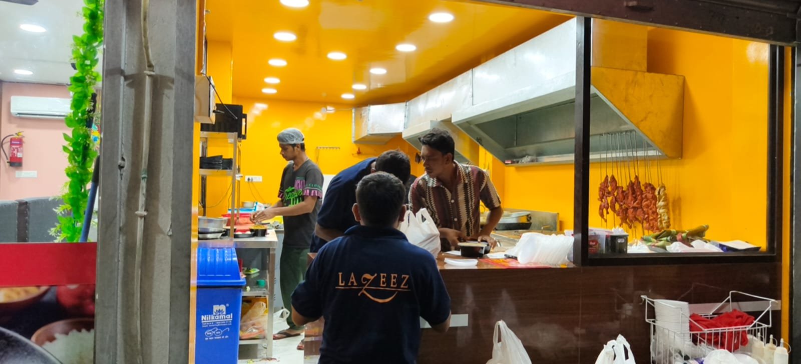 Kitchen team at Lazeez NewTown packing fresh orders